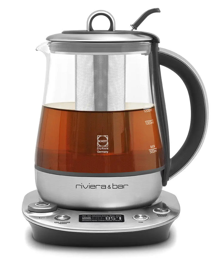 Théière électrique en verre et acier inoxydable.