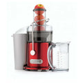 Extracteur de jus rouge avec pommes.
