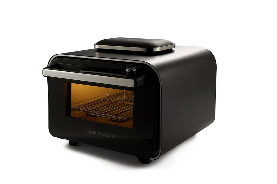 Le four à pizza électrique 400 degrés riviera&bar est doté d'une finition noire, d'une porte transparente, d'un intérieur éclairé, d'une grille et d'un plateau plat - idéal pour les pizzas faites maison et la cuisine italienne authentique dans votre cuisine.