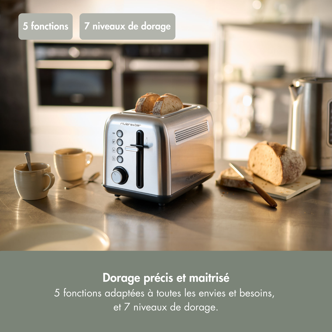 Le grille-pain inox QGP220 riviera&bar à 2 fentes courtes, avec 5 fonctions et 7 niveaux de brunissage, sublime votre comptoir pour un toast parfait.