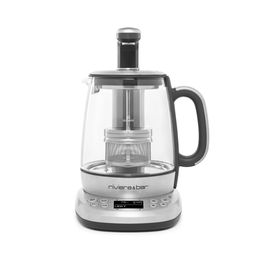 La Théière Cha Dao Expert de riviera&bar est une théière électrique en verre avec un écran digital, des boutons de contrôle, une poignée, un système d'infusion automatique, un panier à thé Monte et Baisse, et un bec verseur.