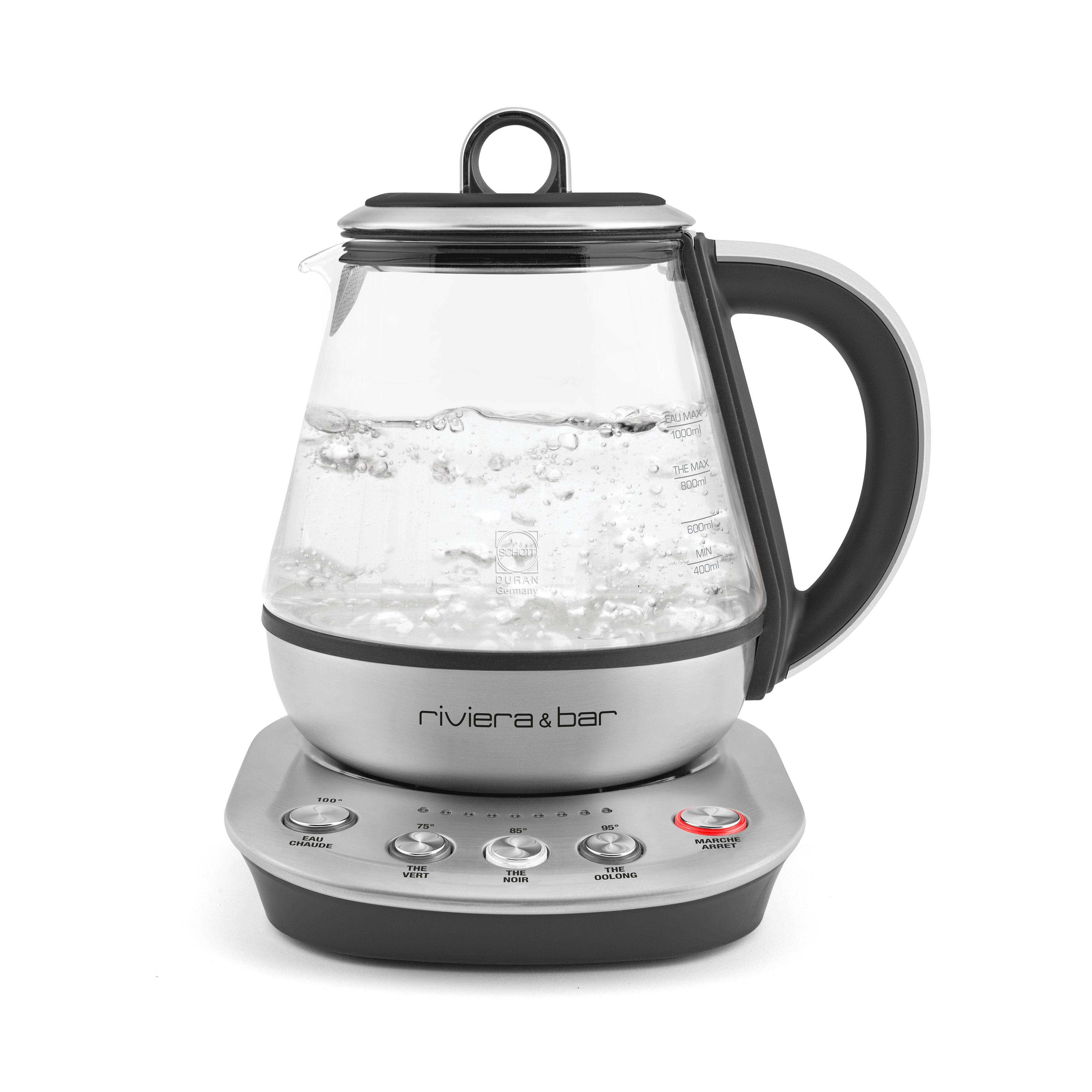 La théière électrique riviera&bar Fujian Zen 0,8L en verre trempé possède une poignée noire, une base argentée et des boutons dont température réglable et bouton lumineux. Elle est partiellement remplie d'eau bouillante.