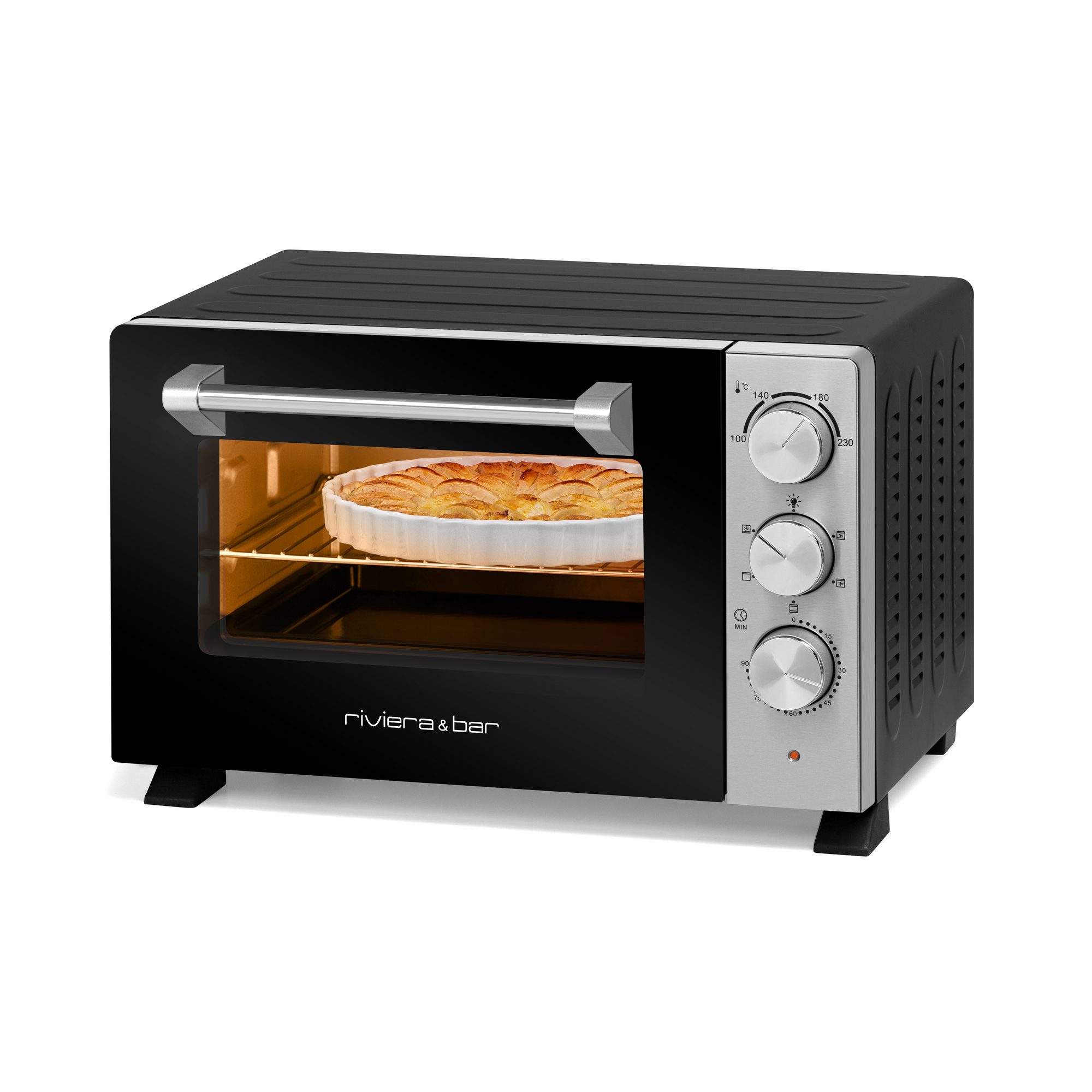 Un four de comptoir riviera&bar Four posable à parois tempérées 21 L noir et argenté avec trois boutons de commande cuit une tarte dans un plat rond blanc ; le four fermé et éclairé utilise la chaleur tournante pour une cuisson uniforme.