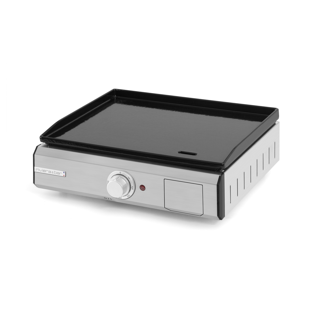 La Plancha riviera&bar fonte émaillée électrique est dotée d'un corps en acier inoxydable, d'un bouton de commande unique, d'un voyant lumineux rouge et d'une surface de cuisson noire plate - idéale pour les petites cuisines ou l'extérieur, garantissant une cuisson précise à chaque fois.