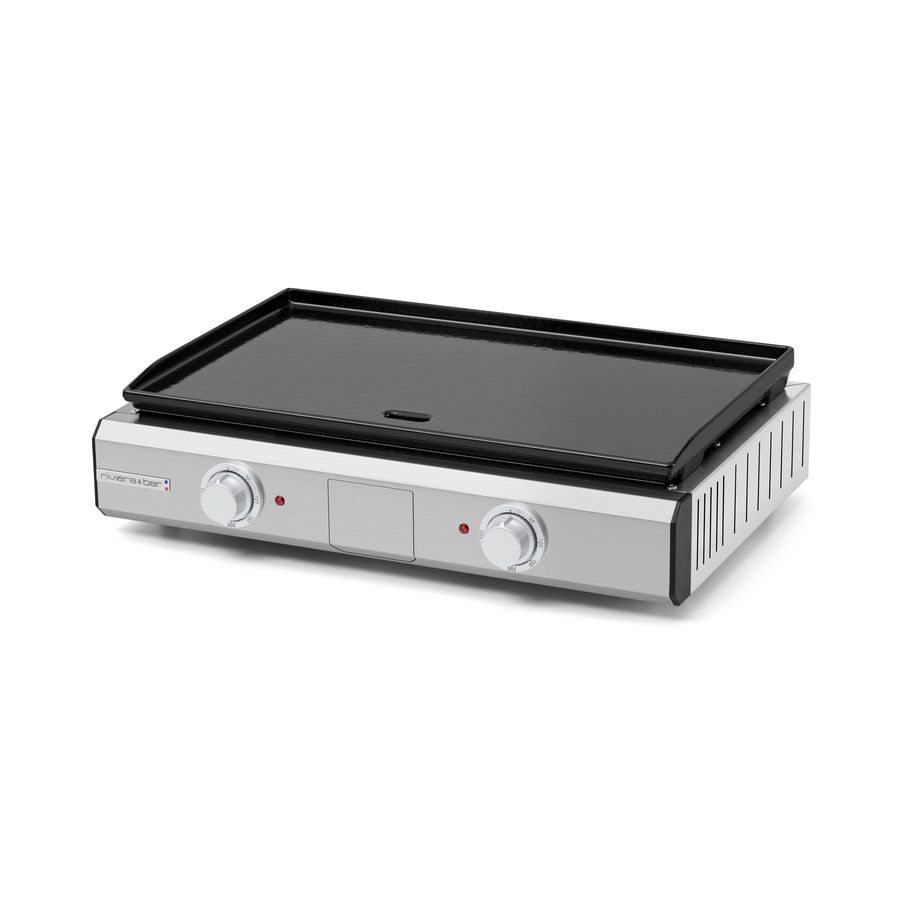 La Plancha intérieur extérieur riviera&bar est une plancha électrique en acier inoxydable avec deux boutons de contrôle et des voyants lumineux à l'avant. Elle est dotée d'une grande surface plane en fonte émaillée pour une cuisson uniforme et antiadhésive.