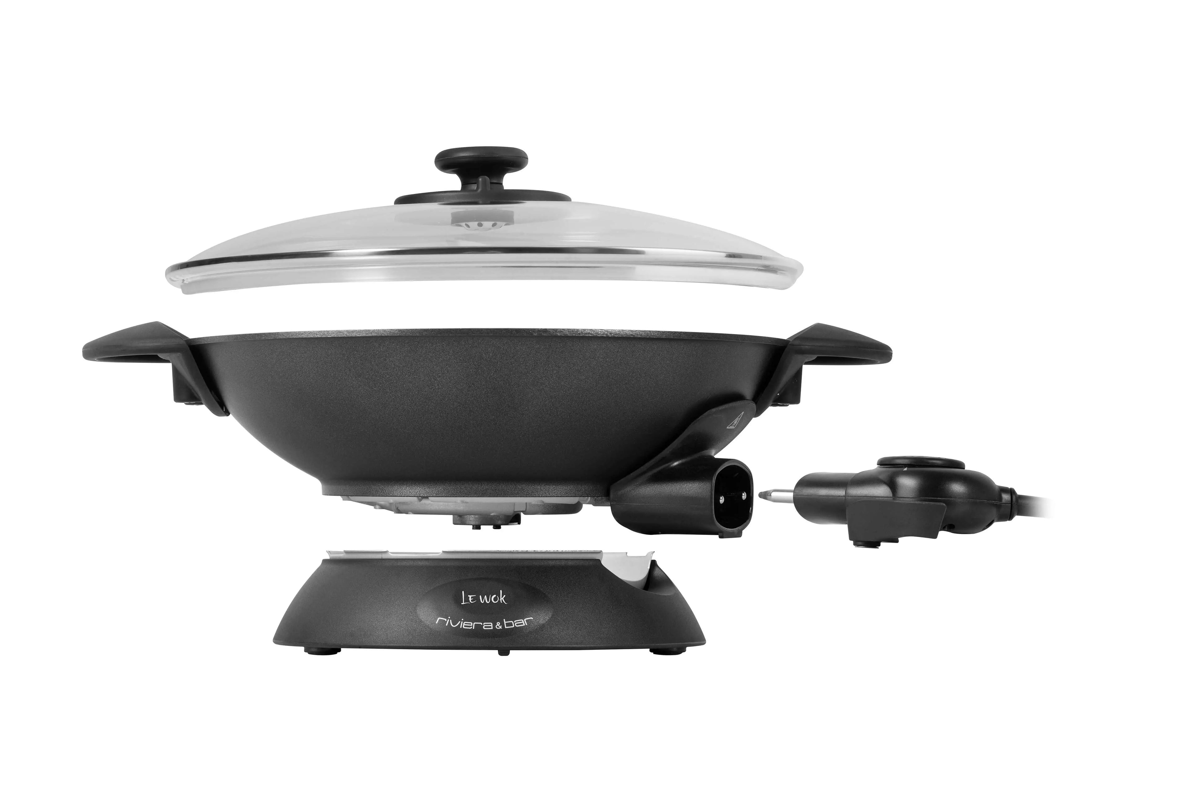 Wok électrique noir avec couvercle en verre.
